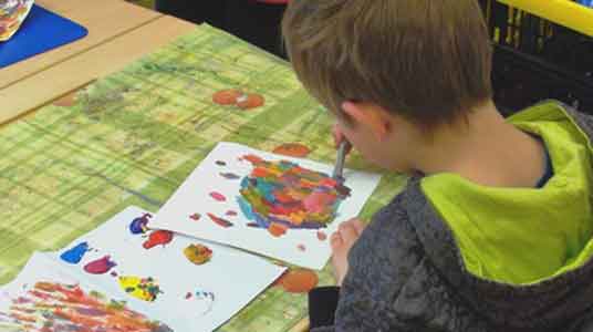 children start painting the background