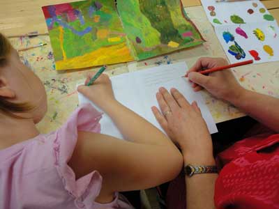 children and parents are painting a part of their environment