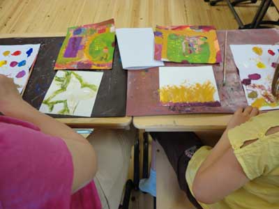 children and parents are painting a part of their environment